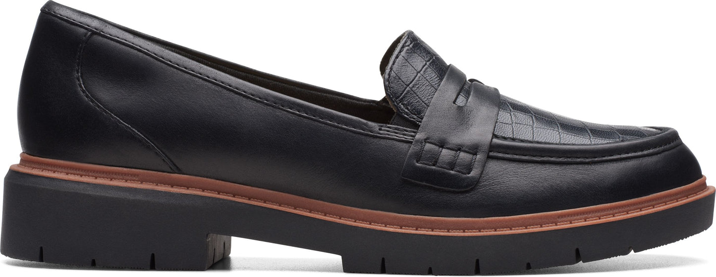 A black leather loafer with a lug sole.