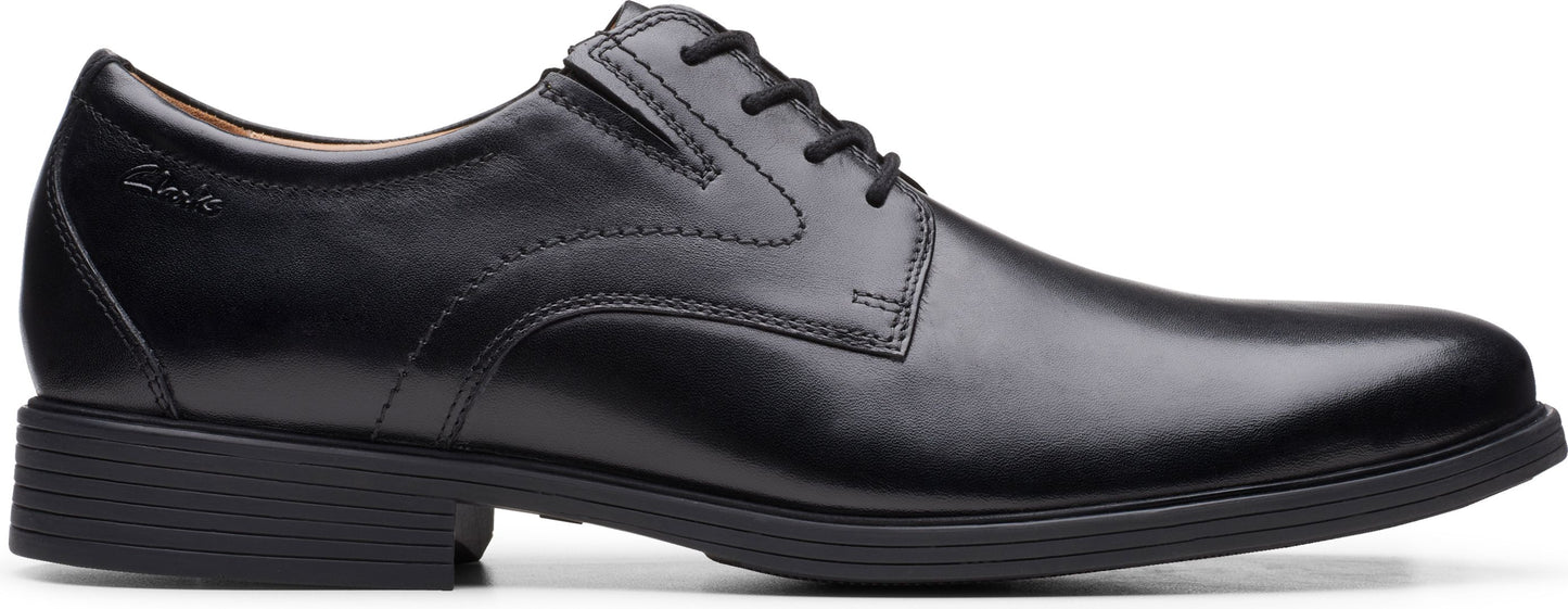 A black leather dress shoe with a lace-up closure and a low heel.