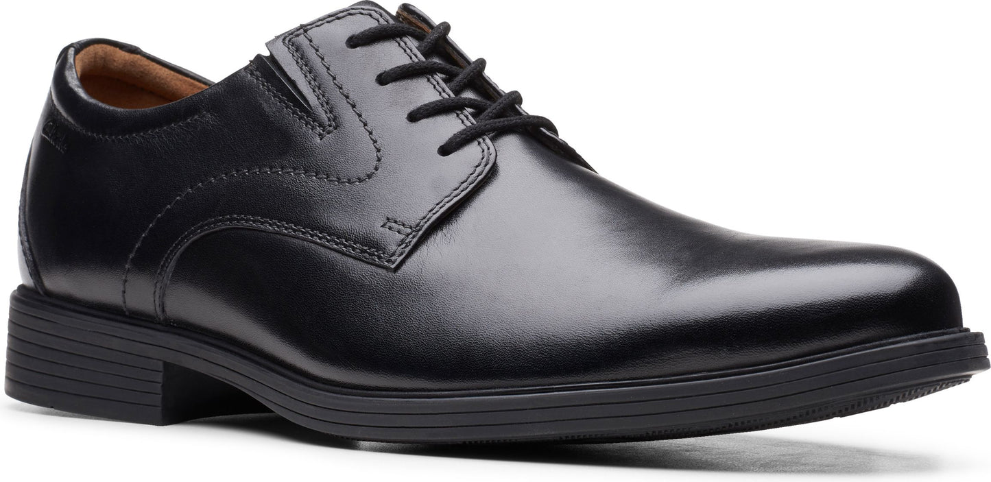 Black leather dress shoe with laces.