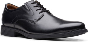 Black leather dress shoe with laces.