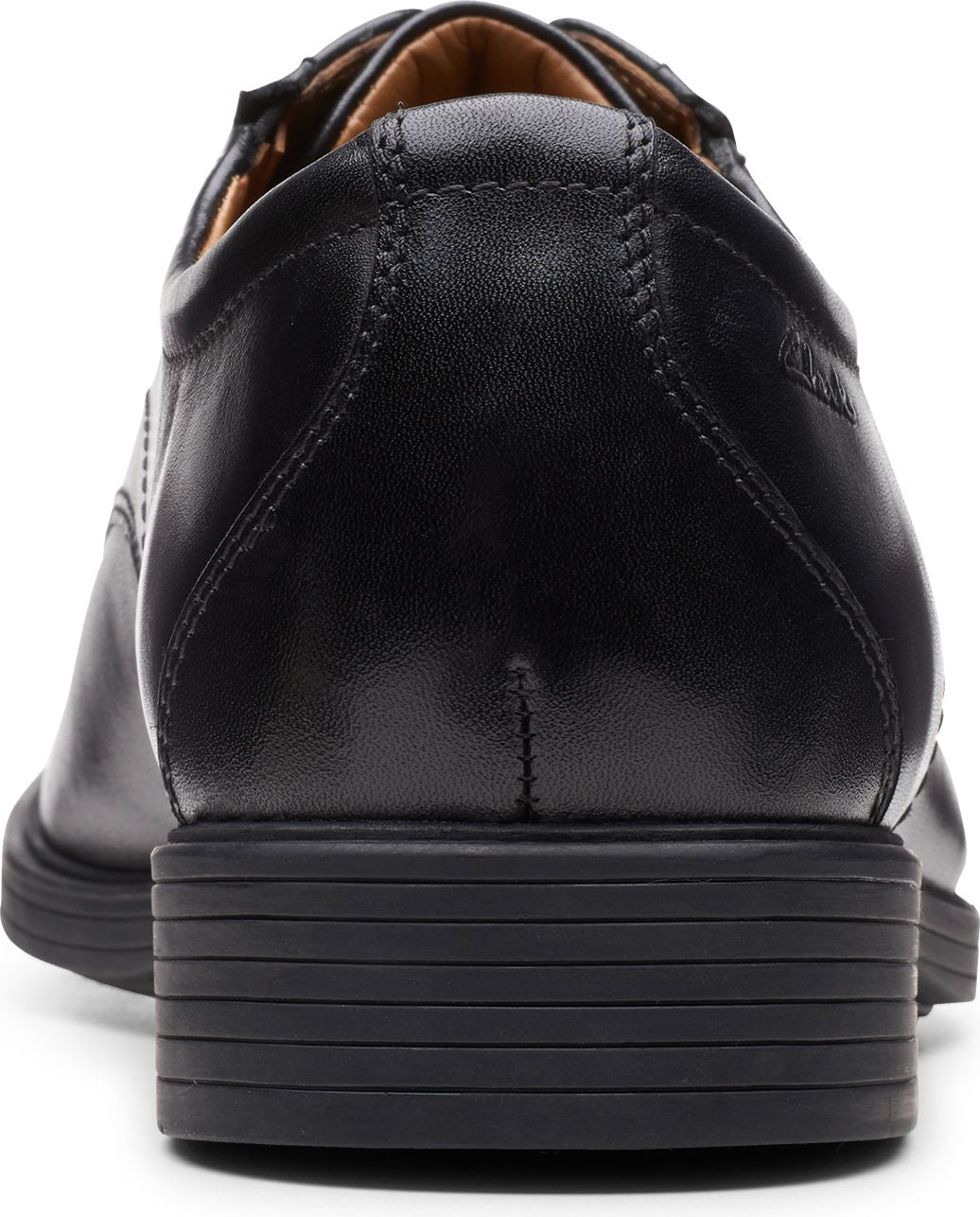 Close-up of back of black leather dress shoe with stacked heel.