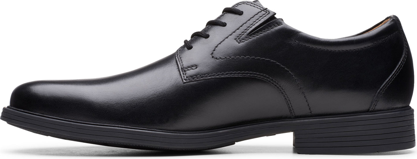 A black leather dress shoe with a lace-up closure and a low heel.