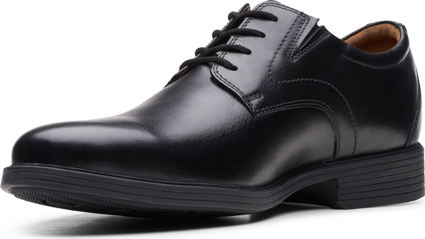 Black leather dress shoe with laces and a low heel.