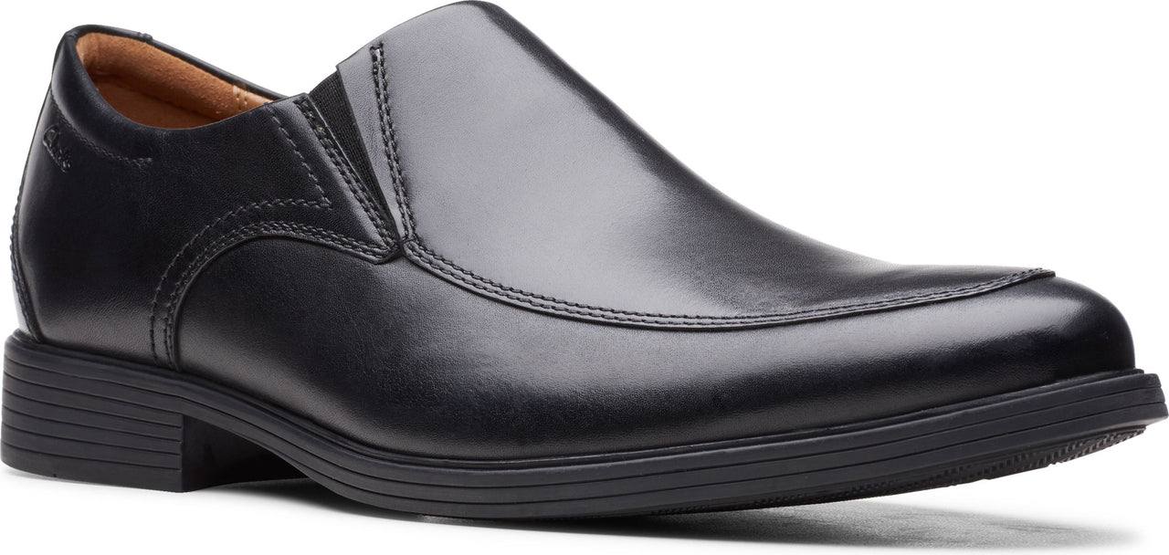 A black leather slip-on dress shoe.