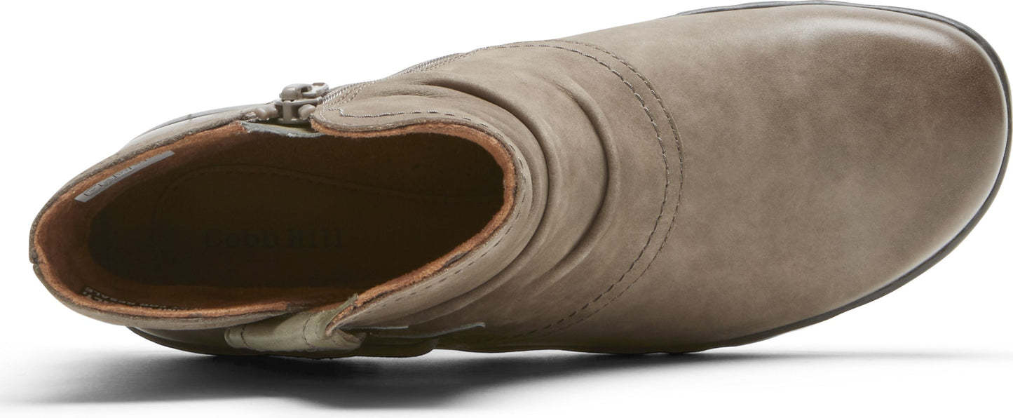 Taupe ankle boot with side zipper and wrinkled texture.