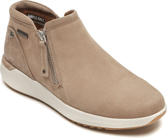 Side view of ankle-high taupe slip-on shoe with a white sole and a side zipper.