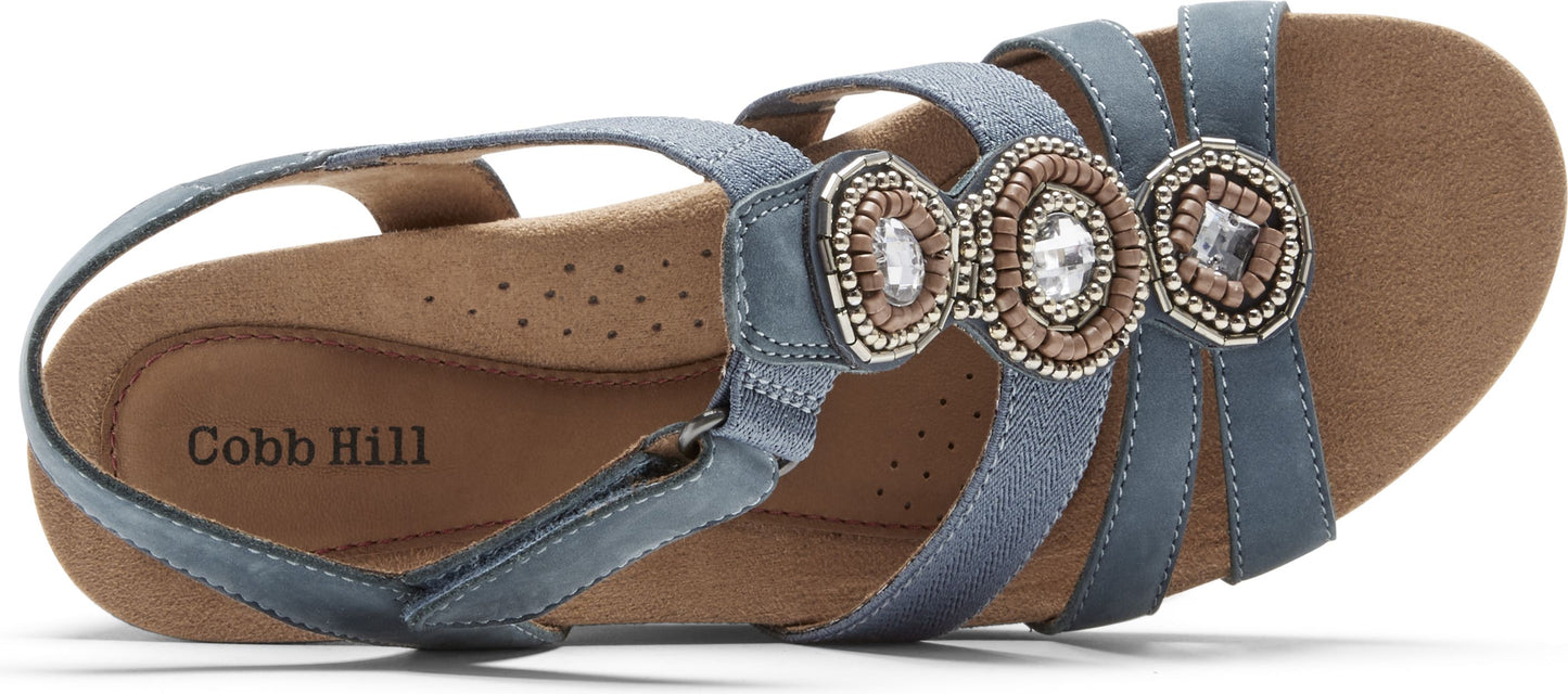 Blue sandal with three decorative beaded circles on the straps.