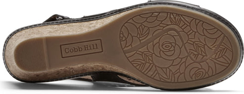The sole of a shoe with flower pattern and the name "Cobb Hill" written on it.