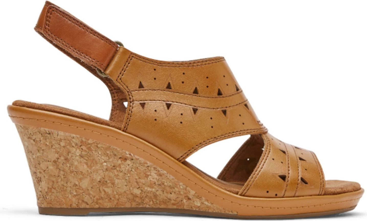 Tan leather sandal with cork wedge heel and triangle cutouts.