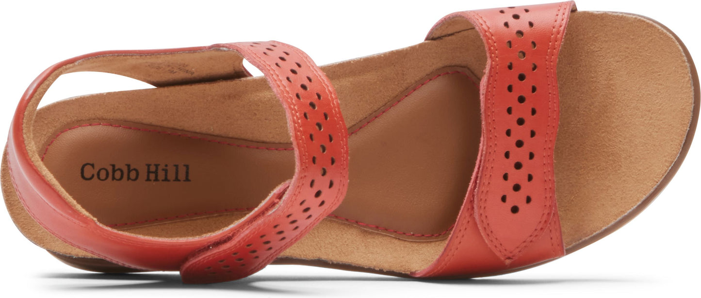 Close-up of a sandal, showing its adjustable perforated strap and Cobb Hill logo.
