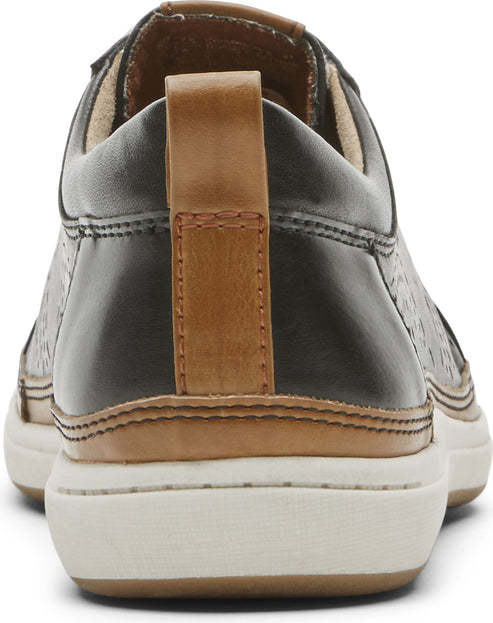 Rear view of black leather slip-on shoe with tan heel pull tab and white sole.