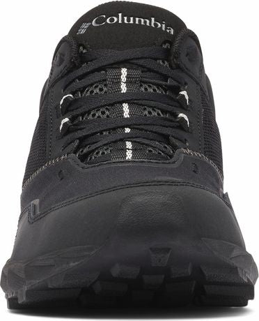 Front view of a black hiking shoe with laces, mesh and "Columbia" text on the tongue.
