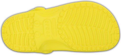 The sole of a yellow clog.