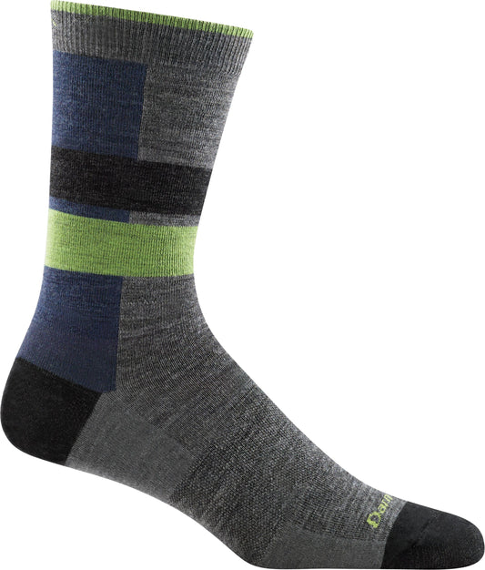 A gray sock with blocks of blue, green, and black.