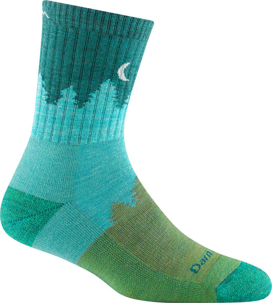 A teal sock with forest tree line and moon, with green heel and toe.