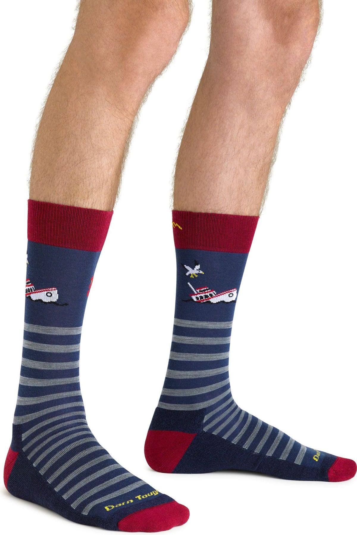 Pair of navy crew socks with red heels and toes, red top, gray horizontal stripes, and embroidered airplane designs.