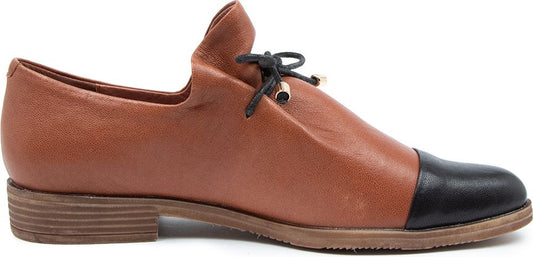 A brown leather shoe with a black toe and a brown stacked heel.