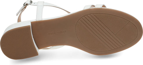 White sandal showing the brown textured sole.