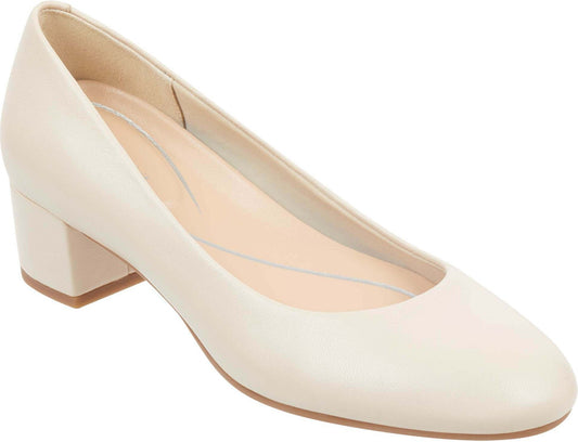 Low-heeled, round-toed, light beige pump shoe.