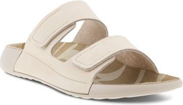 Beige, slip-on sandal with two adjustable hook-and-loop straps.