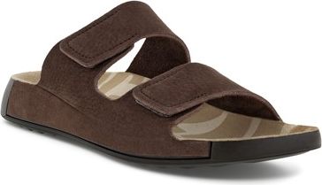 A brown suede sandal with two velcro straps on a tan textured insole with a black sole.