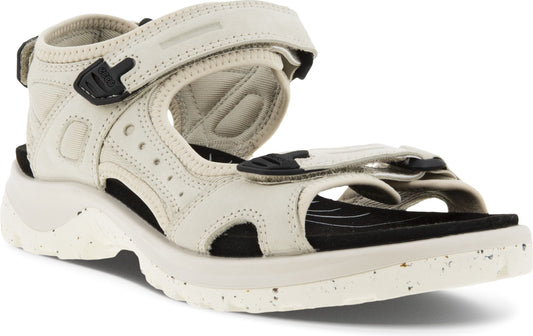 Beige sandal with velcro straps and a chunky white sole.