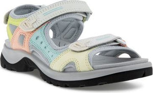 A sandal with velcro straps in pastel colors.