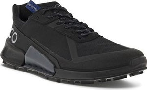 A black athletic shoe with GORE-TEX tag, rugged sole, and reflective laces.