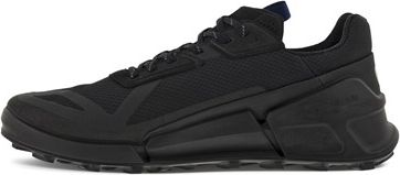 A black sneaker with a thick sole.