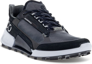 A gray and black waterproof athletic shoe with white accents and rugged tread.
