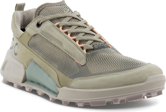 A low cut, olive green sneaker with breathable mesh paneling and a thick, lugged sole.
