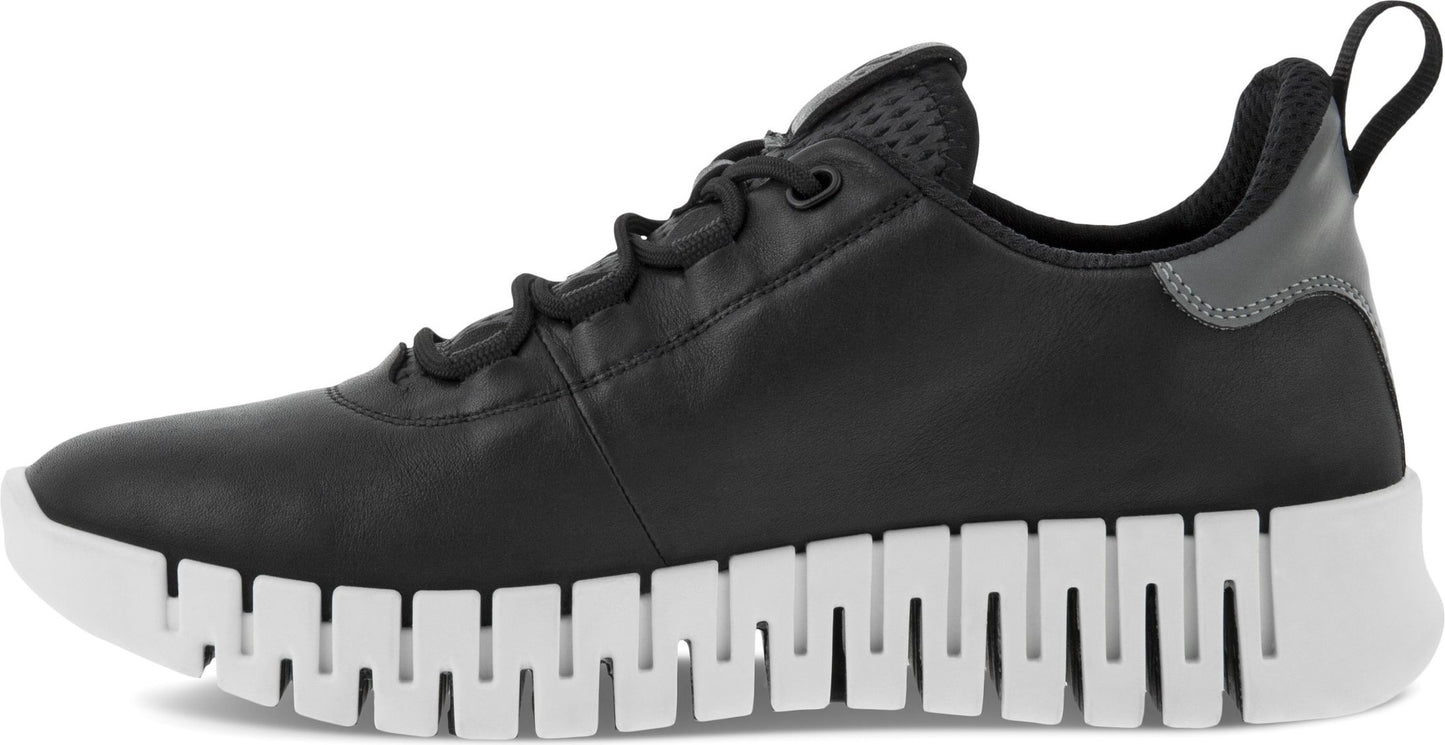 Black leather sneaker with a white crenelated sole.