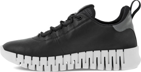 Black leather sneaker with a white crenelated sole.