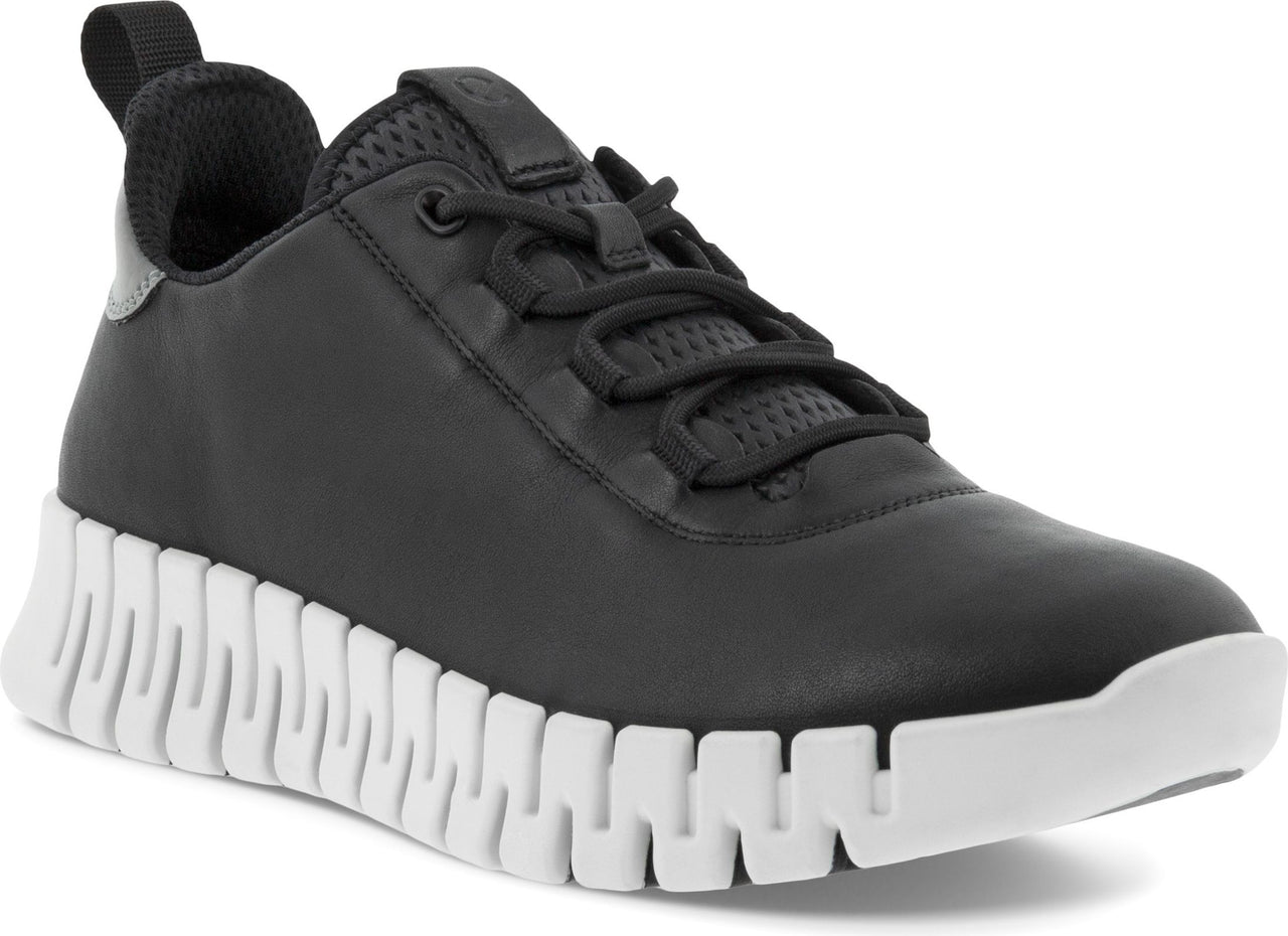 Black sneaker with a unique white, blocky sole, black laces, and a textured upper.