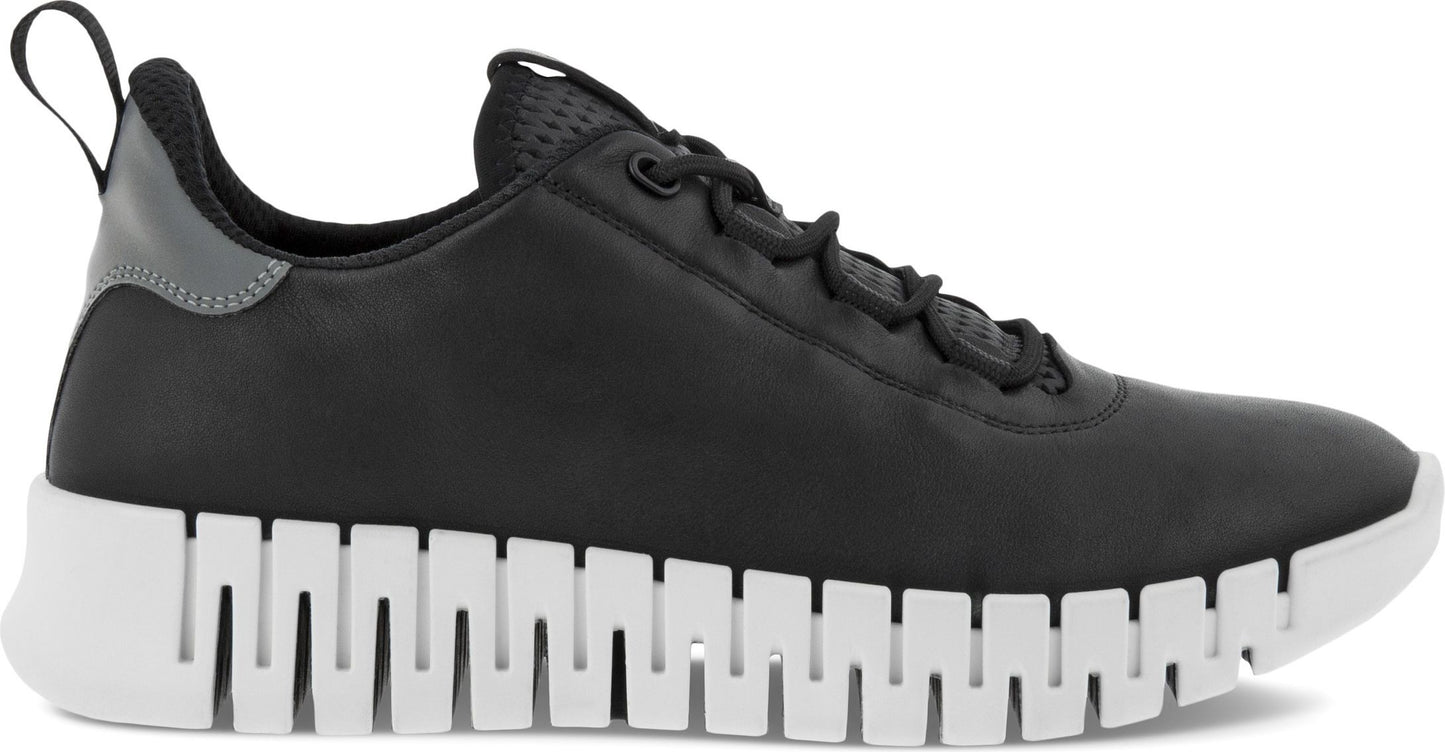 A black sneaker with a white sole and pull tab.