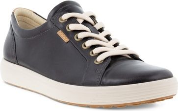 Black leather shoe with white laces and tan sole.