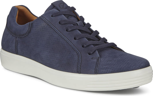 A dark blue suede low top sneaker with a white sole and tan interior.