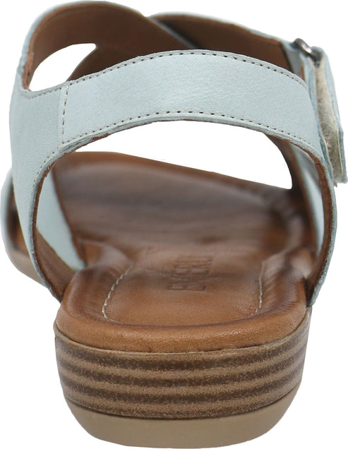 Light blue sandal with brown sole and stacked heel.