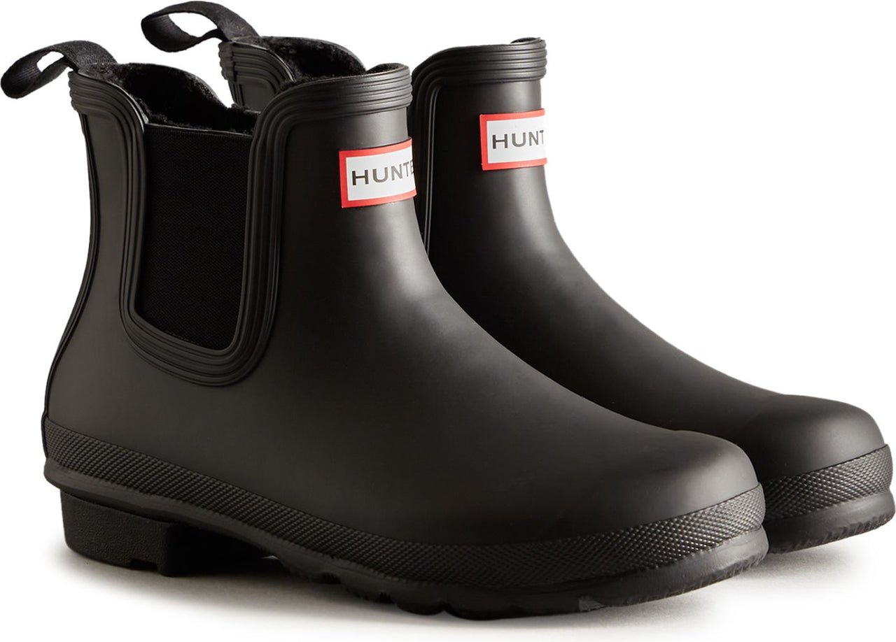 Pair of matte black rubber Chelsea rain boots with a red and white square logo on the side.