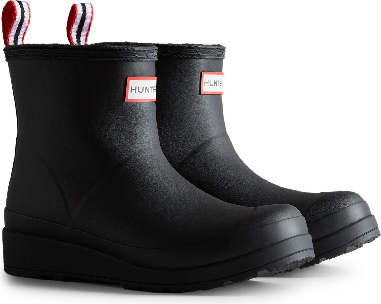 Pair of black rubber ankle-height rain boots with red, white, and blue pull tabs and logo patches.