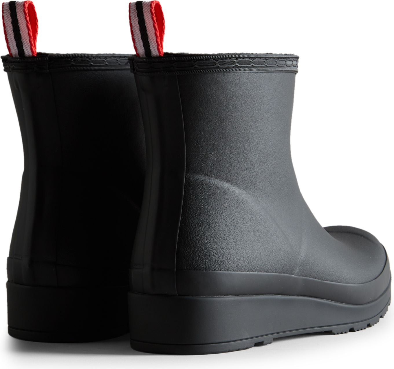 Black rubber ankle boots with block heels and red and white striped pull-tabs.