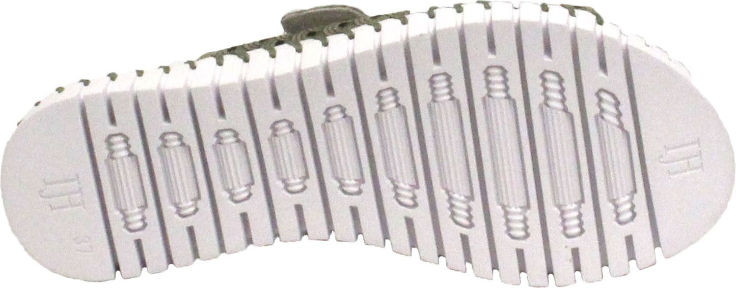 The sole of a shoe with a white, ribbed tread.