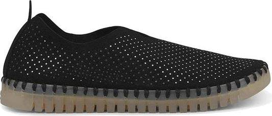 A black slip-on shoe with small perforations and a tan rubber sole.