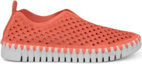 A coral-colored slip-on shoe with a perforated upper and a white, ridged sole.