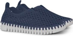 Navy slip-on shoe with perforated upper and white cleated sole.
