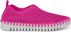 A slip-on style shoe in bright pink with a white sole featuring a unique ridged design.