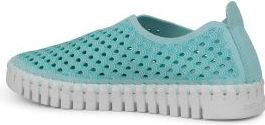 A slip-on shoe in turquoise with decorative perforations and a thick, white, cleated sole.