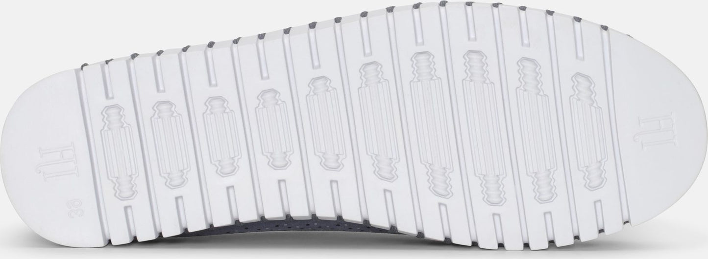 Close-up of a white shoe sole with ridged texture.