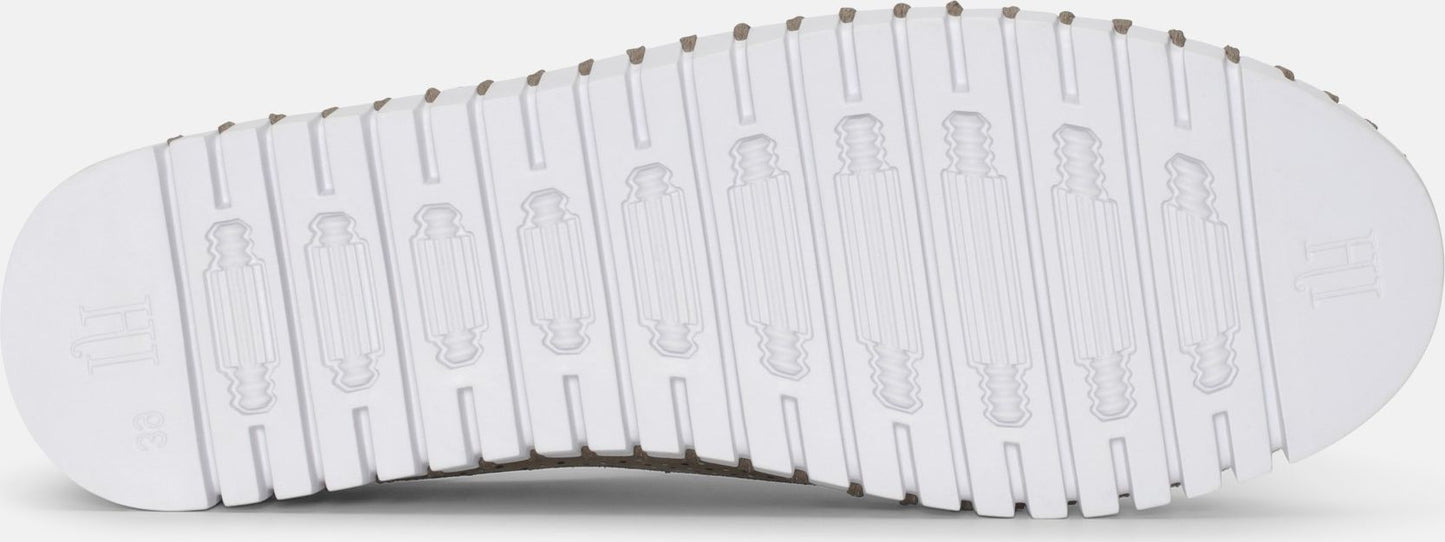 The shoe has a grooved white sole.