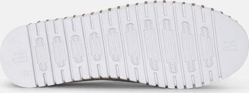 The shoe has a grooved white sole.